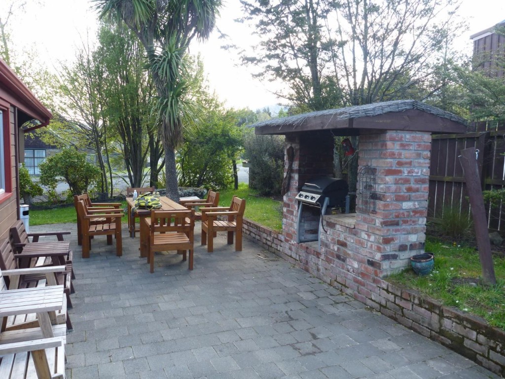 The outdoor dining table and BBQ. 