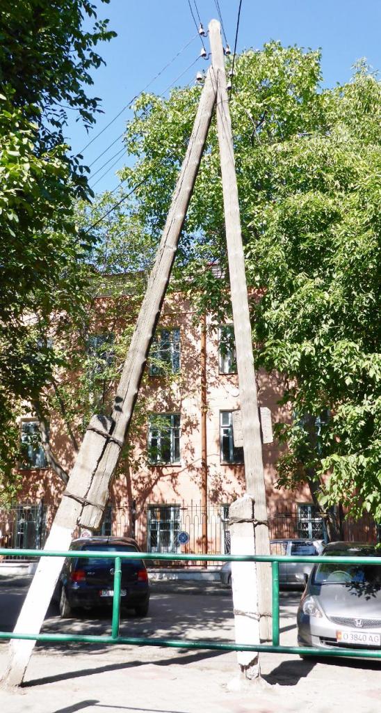 This is an interesting way to support a power pole - strapped to bent concrete posts. 
