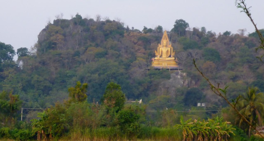 A large hillside Buddha. 