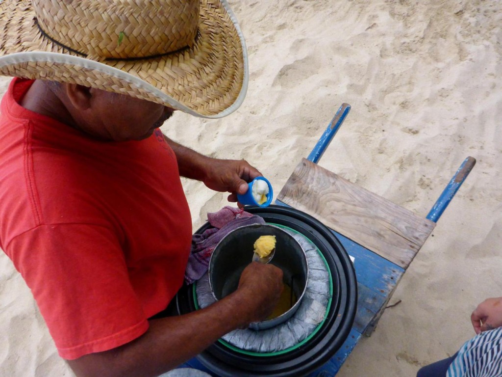 A guy walking the beach selling homemade coconut ice cream. 