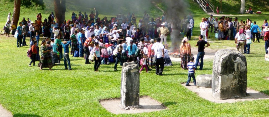 The ceremony is getting larger. On the right is a round sacrifice stone. The headstone in front was used as a "whiteboard" listing when the next sacrifice was to be held and what was needed to be placed on the stone. In the fire ring is wood and whole pieces of corn. 
