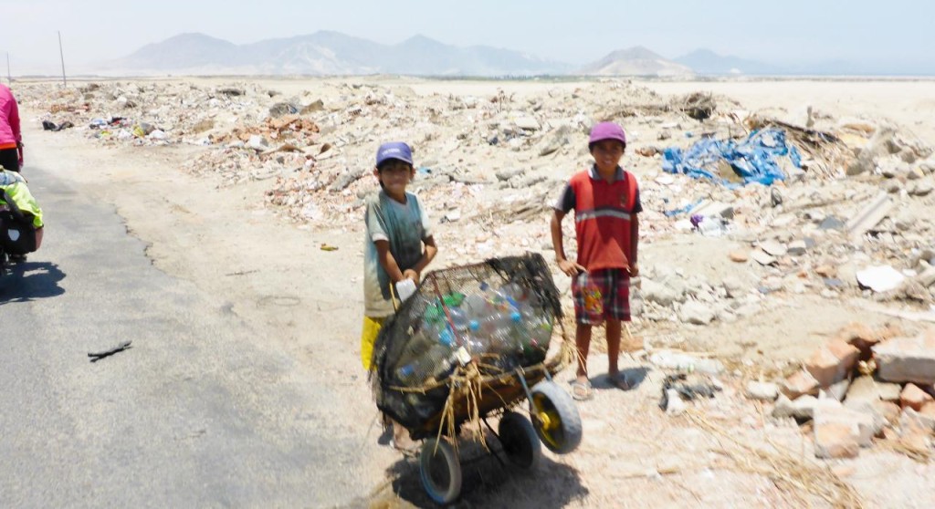 These boys should be in school. They are collecting plastic bottles from a roadside dump. These bottles are reused and filled with homemade fruit juice. This could have been what made us sick as I doubt if the bottles are more than rinsed with cold water. The caps are not sealed. 