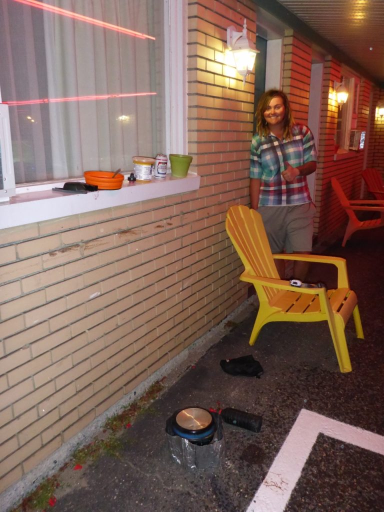 Jocelyn cooking outside our motel room in the rain.